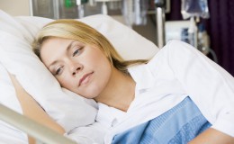 Woman Lying Down In Hospital Bed